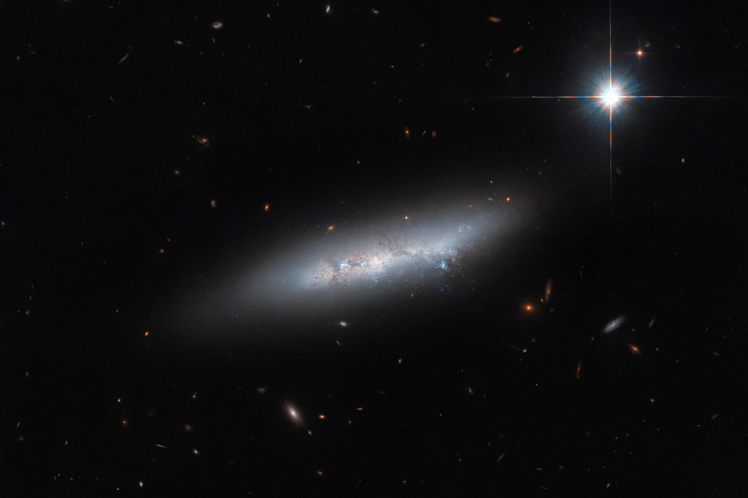 Deceptive loneliness: Hubble photographs spiral galaxy NGC 2814