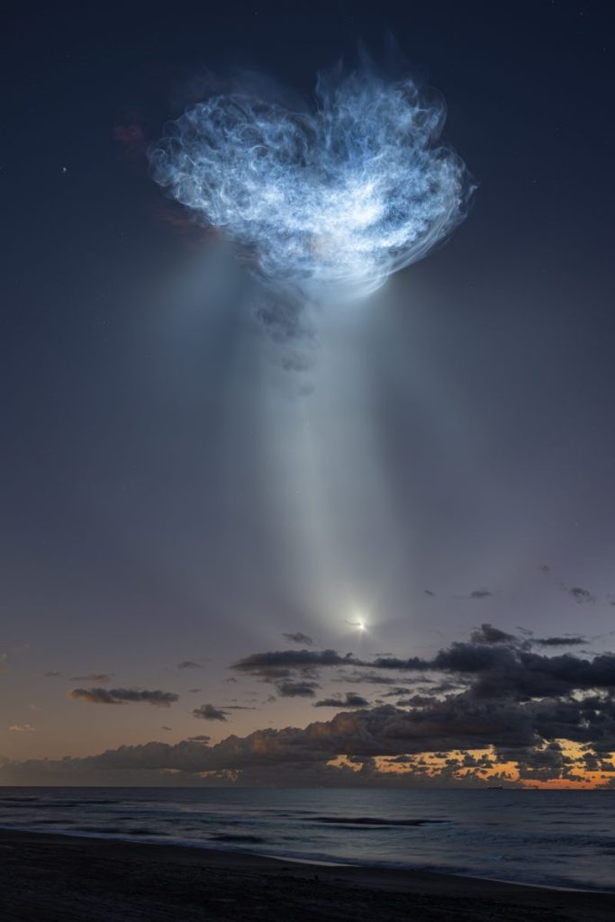 Підсвічений сонцем вихлоп ракети Falcon 9 з кораблем Dragon у передсвітанковому небі