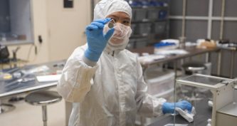 Інженер NASA зважує дослідні твердотільні батареї після термовакуумних випробувань
